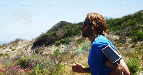 Jogger Using Smartphone for Fitness Tracking on Mountain Trail