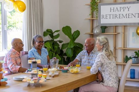 Senior Friends Celebrating Retirement at a Cheerful Home Gathering