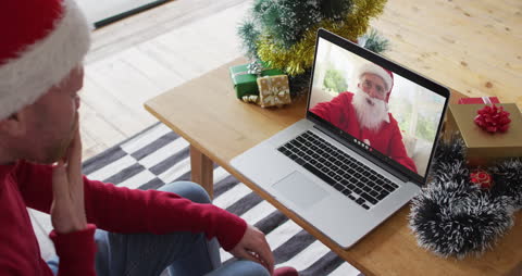Man Having Video Call with Santa Claus during Christmas Festivities