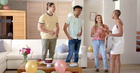 Friends Socializing at Home with Balloons and Drinks