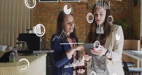 Two Businesswomen Analyzing Data on Digital Tablet