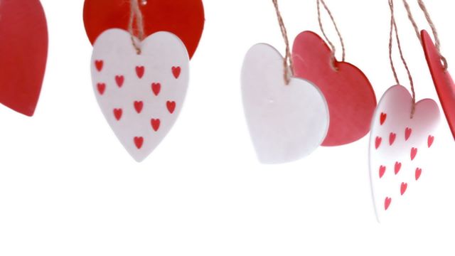 Red and white heart-shaped ornaments hanging on strings, evoking a sense of romance and affection. Perfect for decorations on Valentine’s Day or any romantic setting, these ornaments add a charming and festive touch. Their simple yet striking design makes them ideal for home decor, party decorations, or crafting projects.