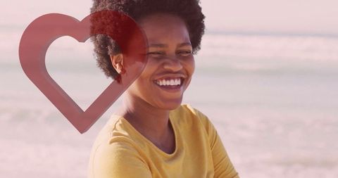 Joyful Woman with Heart Silhouette at Beach