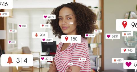 Smiling Woman Engaged with Social Media Notifications in Modern Office