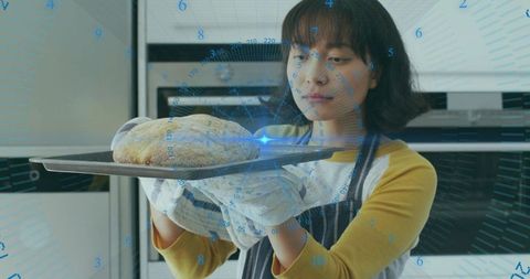 Asian Woman Baking Bread with Digital Technology Concept