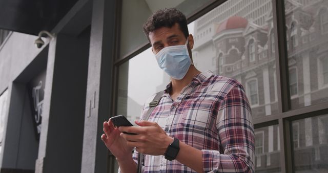 Young Man in Mask Using Smartphone on City Street - Download Free Stock Images Pikwizard.com