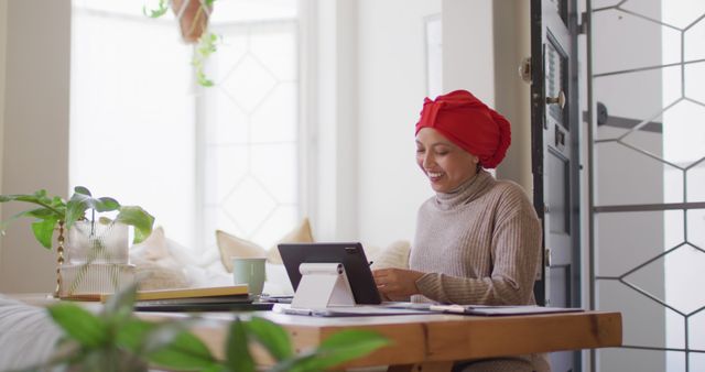 Smiling Woman Wearing Headscarf Using Tablet at Home Office - Download Free Stock Images Pikwizard.com