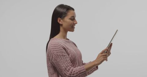 Woman using tablet engaging with digital content