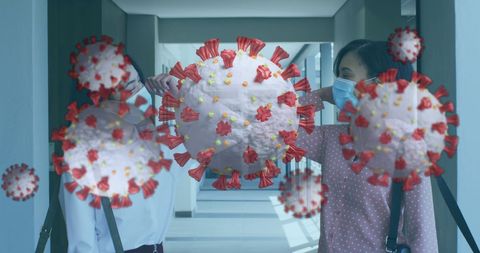 Colleagues greeting contrasting covid-19 cells multiplying