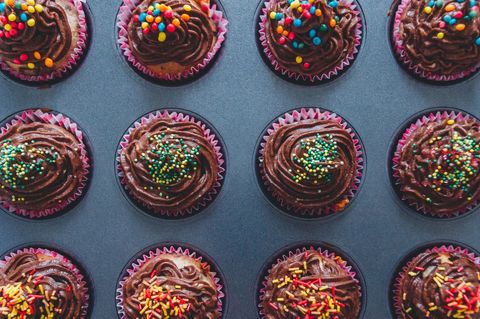 Assorted chocolate cupcakes with colorful sprinkles from overhead view