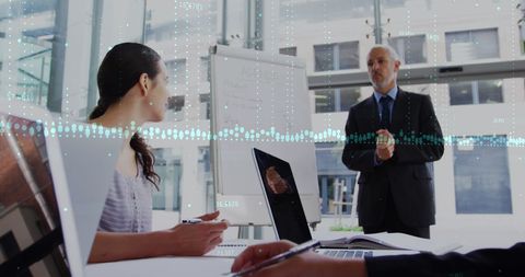 Diverse Business Team Discussing Analytics in Modern Office