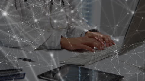Doctor Typing on Laptop with Digital Network Overlay