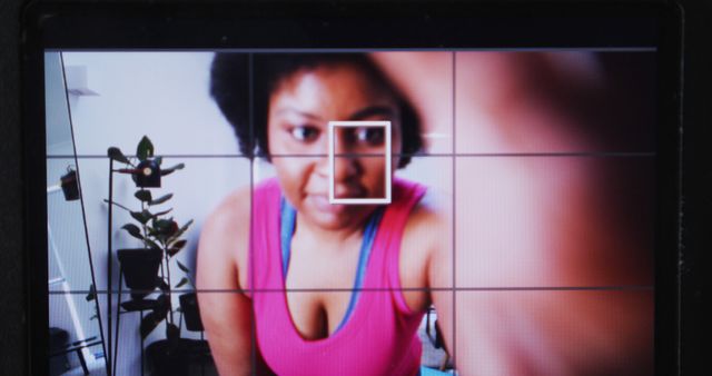 African American woman taking selfie in pink top through camera viewfinder - Download Free Stock Images Pikwizard.com