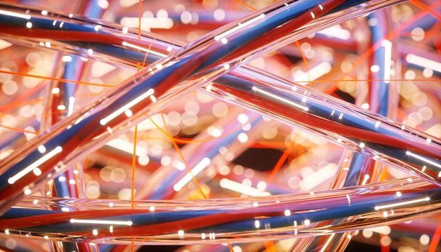 Interwoven chrome tubes reflecting neon light and glowing orange filaments in macro with bokeh