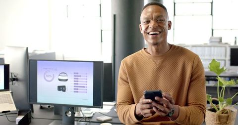 Confident Businessman Engaging with Technology in Modern Office