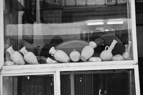 Antique clay pots displayed in shop window