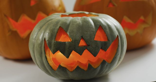 Close up view of scary face carved halloween pumpkin against grey background. halloween holiday and celebration concept