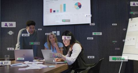 Asian woman leading data-driven team meeting with laptops, dashboard analytics and social metrics
