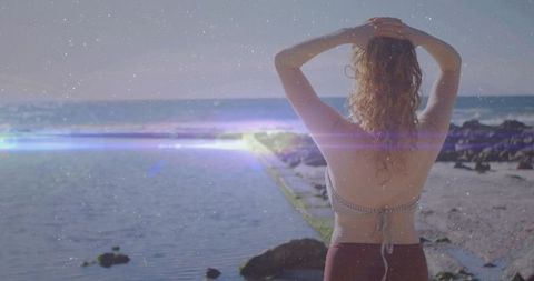 Woman Relaxing by Tidal Pool with Ocean View