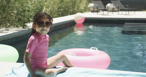 Young Girl in Heart Sunglasses by Pool Sunlit Summer Leisure