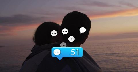 Couple Embracing at Coast with Digital Communication Icons at Sunset