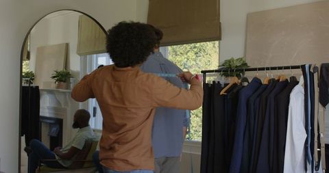 Tailor adjusting suit for wedding ceremony preparation