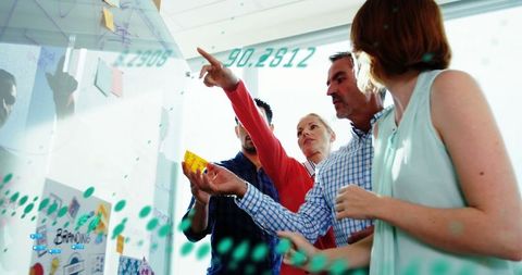 Diverse team analyzing data in collaborative office meeting