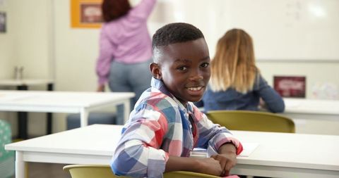 Smiling African American Boy in Classroom Setting