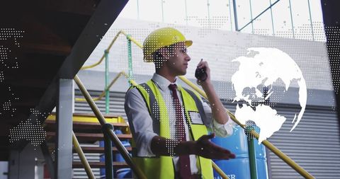 Warehouse Supervisor Communicating Over Radio While Gesturing on Stairs with Globe Overlay