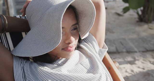 Relaxed Young Woman Enjoying Sun on Beach Chair - Download Free Stock Images Pikwizard.com