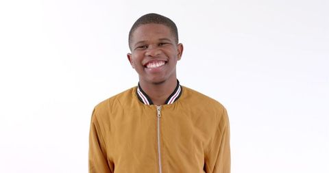 Cheerful African American Man in Fashionable Jacket Smiling Confidently