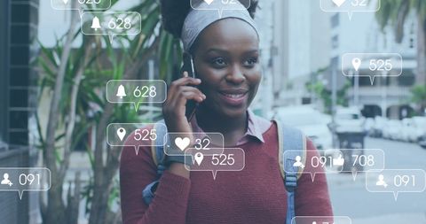 Smiling African American Woman Engaging with Social Media on Smartphone