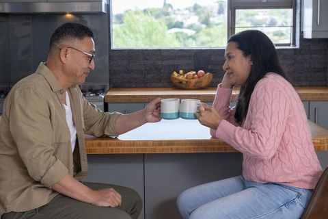 Father and Daughter Sharing Coffee Moment at Home Kitchen Island