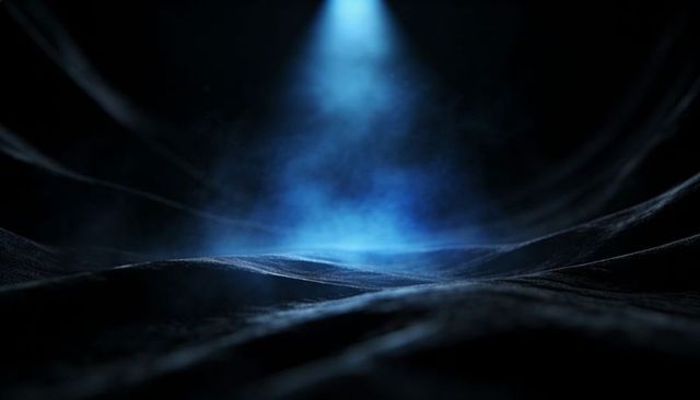 Indigo Spotlight Casting Mist over Rippled Black Surface with Rising Blue Fog and Haze