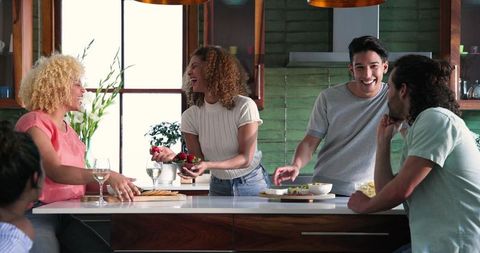 Diverse Group of Friends Enjoying Kitchen Gathering and Celebration