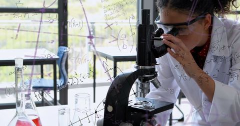 Female Scientist Examining through Microscope with Math Background - Download Free Stock Images Pikwizard.com