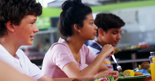 Diverse Group of Teenagers Eating Lunch Together in Cafeteria - Download Free Stock Images Pikwizard.com