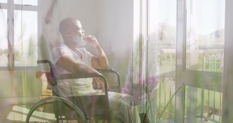 Contemplative Man in Wheelchair Surrounded by Nature