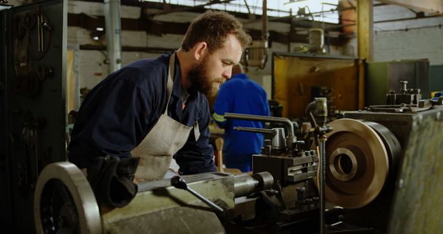 Male Industrial Worker Operating Lathe Machine in Factory - Download Free Stock Images Pikwizard.com