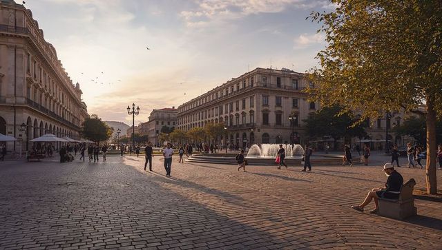 Golden hour european city square with fountain, strolling crowd and historic architecture