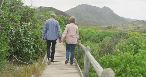 Senior Couple Enjoying Nature Walk on Scenic Boardwalk - Download Free Stock Images Pikwizard.com