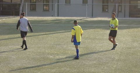 Youth Soccer Team Discussing Strategy on Sunny Day