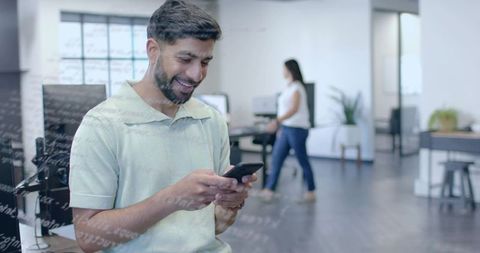 Office Employee Engaged on Smartphone in Modern Workspace