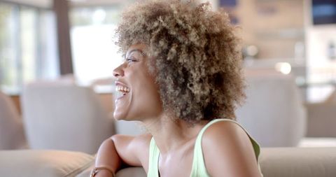 Joyful Woman Laughing Casually at Home in Relaxed Ambiance