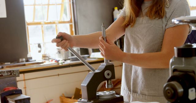 Woman using manual drill press in workshop - Download Free Stock Images Pikwizard.com