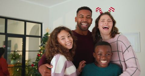 Diverse family celebrating together around christmas tree