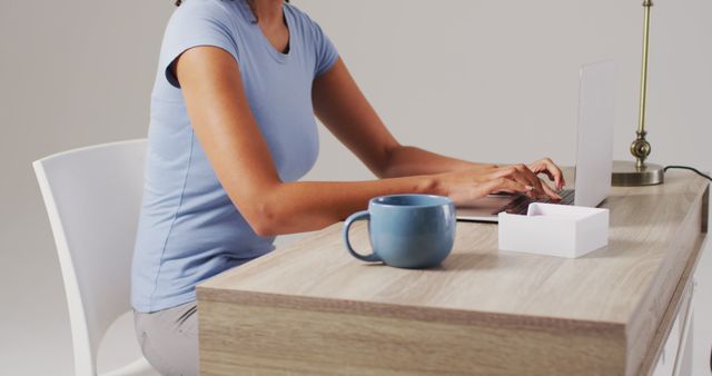 Young Woman Working at Modern Desk with Laptop and Coffee Mug - Download Free Stock Images Pikwizard.com