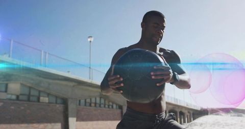 Athlete Engaging in Dynamic Beach Workout with Medicine Ball