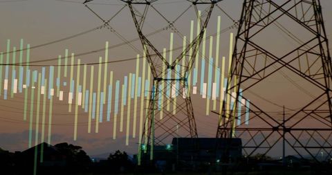 High-voltage transmission towers at dusk showing data overlay for energy grid analytics