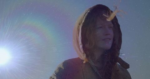 Woman with Hood at Dawn Bathed in Sunlight